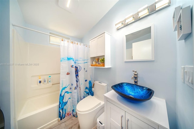 bathroom with shower / tub combo with curtain, vanity, toilet, and wood finished floors