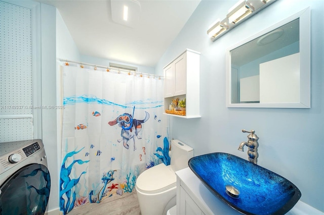 bathroom with toilet, a shower with curtain, washer / clothes dryer, and vanity