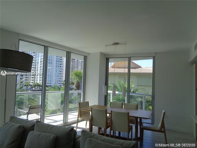 dining area with a healthy amount of sunlight, baseboards, floor to ceiling windows, and wood finished floors