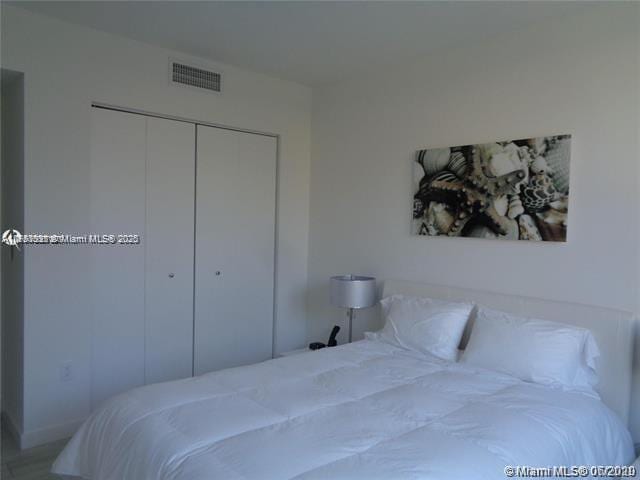 bedroom with a closet and visible vents