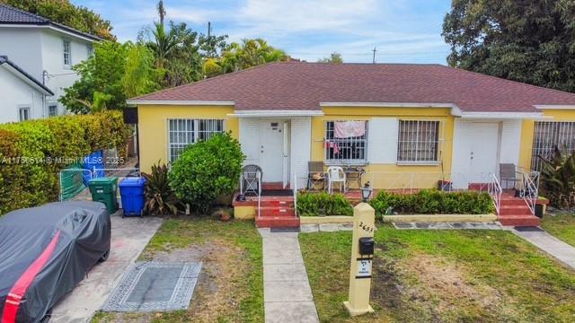 bungalow-style home with a front yard