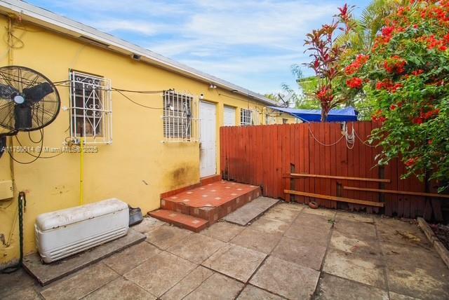 view of property exterior featuring a patio area, fence, and stucco siding