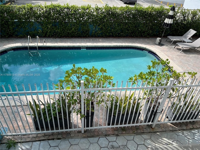 view of swimming pool with a fenced in pool, a patio area, and fence