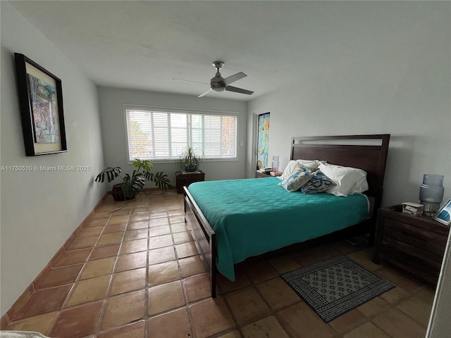 bedroom featuring ceiling fan and tile patterned flooring