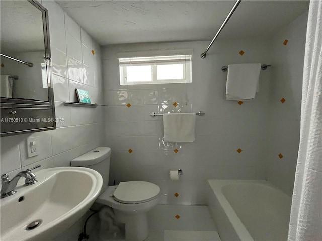 bathroom with a sink, tile walls, and toilet