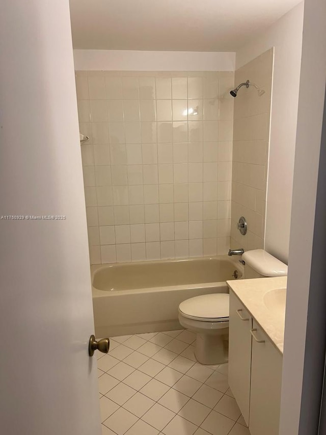 bathroom featuring  shower combination, tile patterned flooring, toilet, and vanity