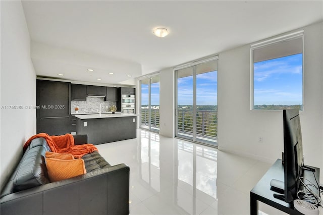 living area featuring recessed lighting, floor to ceiling windows, and light tile patterned floors