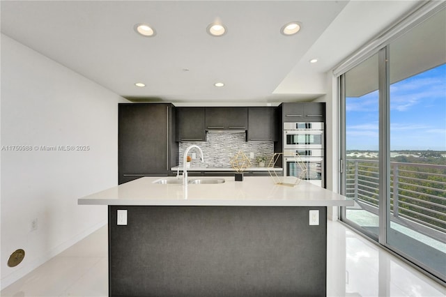 7875 NW 107th Ave Unit 518, Doral, FL 33178 - kitchen with a sink, decorative backsplash, stainless steel double oven, and light countertops