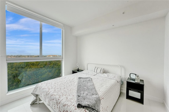 tiled bedroom featuring baseboards