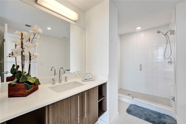 bathroom with a stall shower, tile patterned flooring, visible vents, and vanity