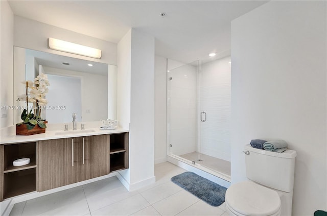 bathroom featuring a stall shower, baseboards, toilet, tile patterned flooring, and vanity