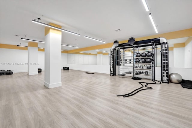 gym featuring wood finished floors and baseboards