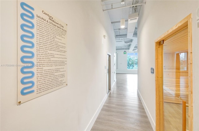 7875 NW 107th Ave Unit 518, Doral, FL 33178 - corridor with baseboards, wood finished floors, and a towering ceiling