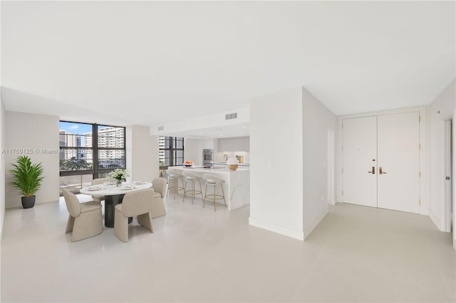 5500 Collins Ave Unit 802, Miami Beach, FL 33140 - dining space with a wall of windows and visible vents
