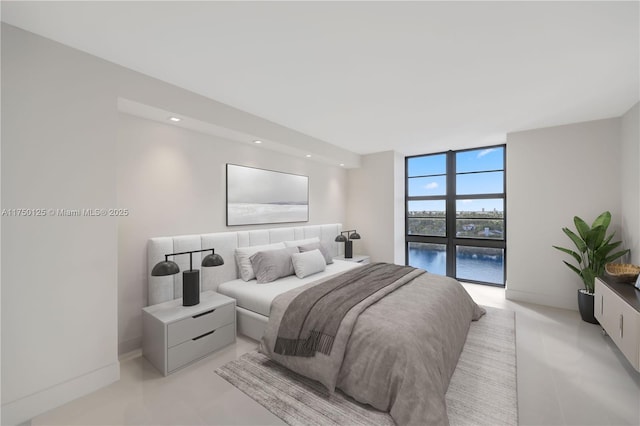 5500 Collins Ave Unit 802, Miami Beach, FL 33140 - bedroom with a wall of windows, baseboards, and recessed lighting