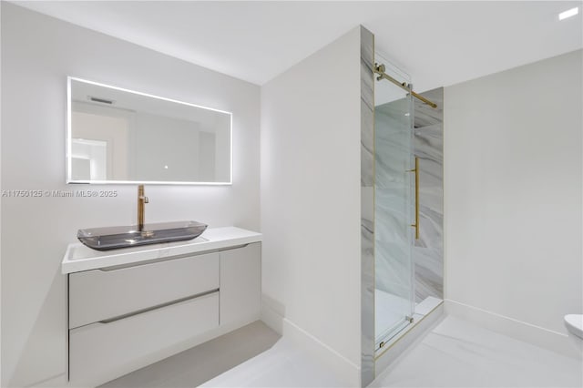 5500 Collins Ave Unit 802, Miami Beach, FL 33140 - bathroom with visible vents, vanity, marble finish floor, baseboards, and a marble finish shower