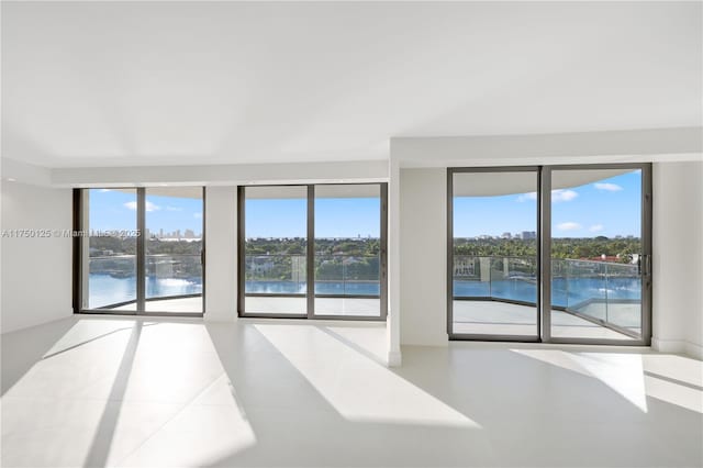 5500 Collins Ave Unit 802, Miami Beach, FL 33140 - tiled spare room featuring a water view