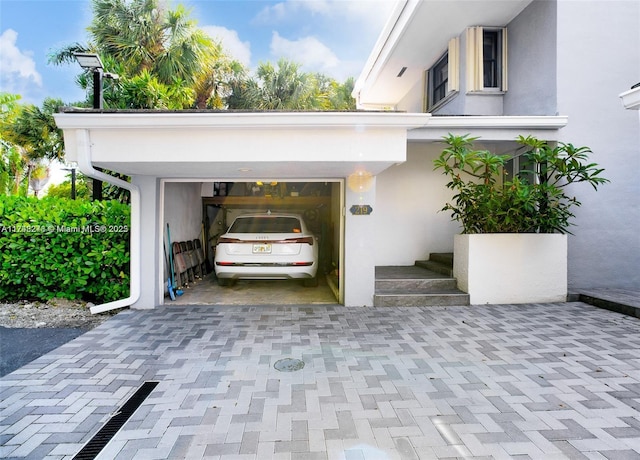 exterior space with decorative driveway and an attached garage