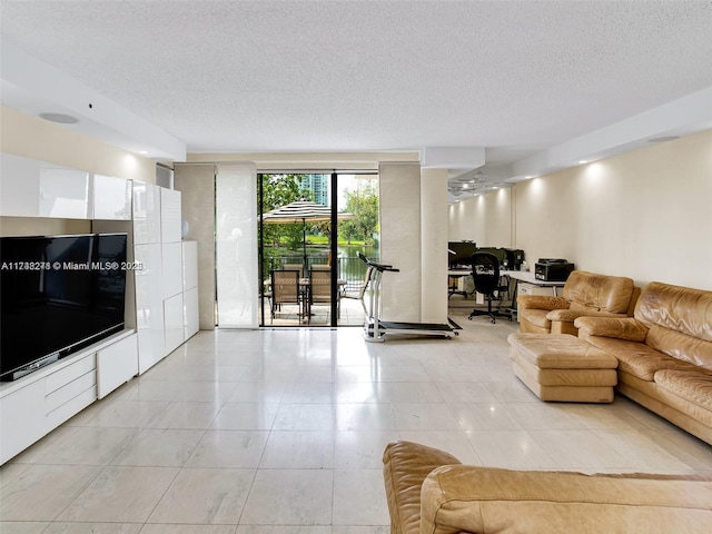 living area with light tile patterned floors and a textured ceiling