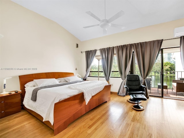 bedroom featuring light wood-type flooring, access to outside, multiple windows, and vaulted ceiling