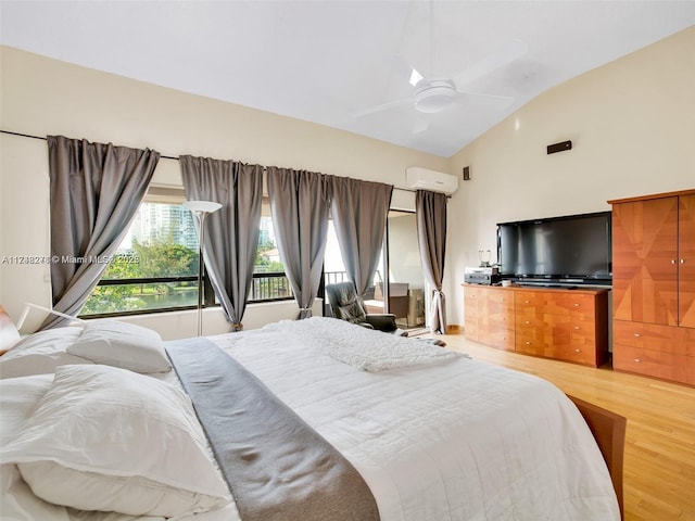 bedroom featuring lofted ceiling, a wall unit AC, a ceiling fan, and wood finished floors