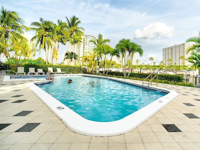 community pool featuring a patio area and fence