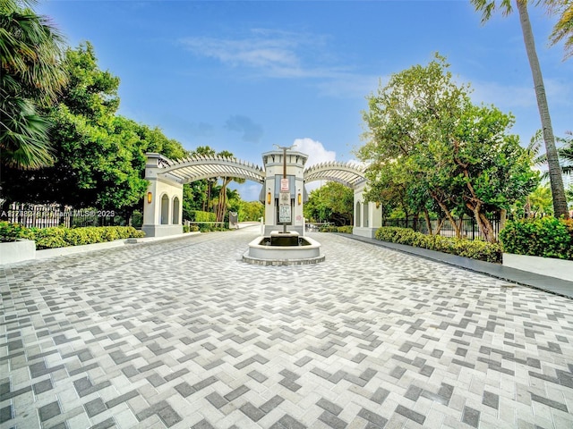 surrounding community with fence and a pergola