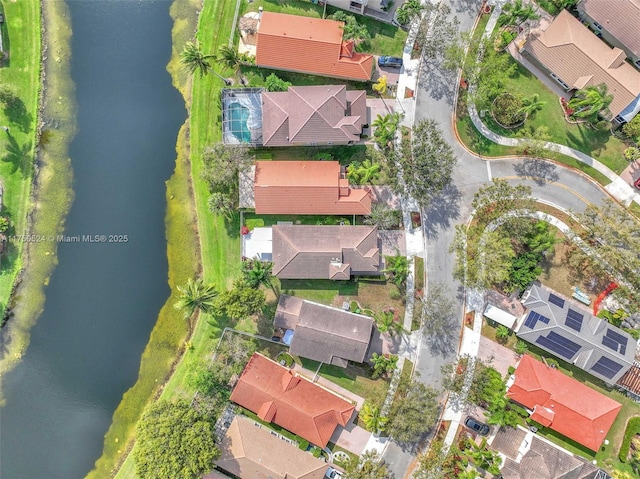 birds eye view of property with a water view and a residential view