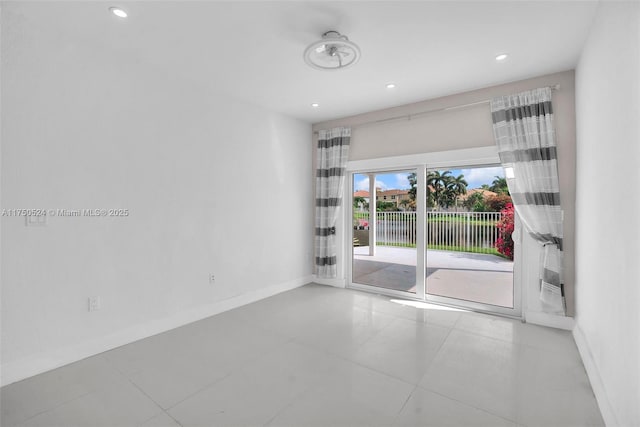 unfurnished room featuring recessed lighting and baseboards