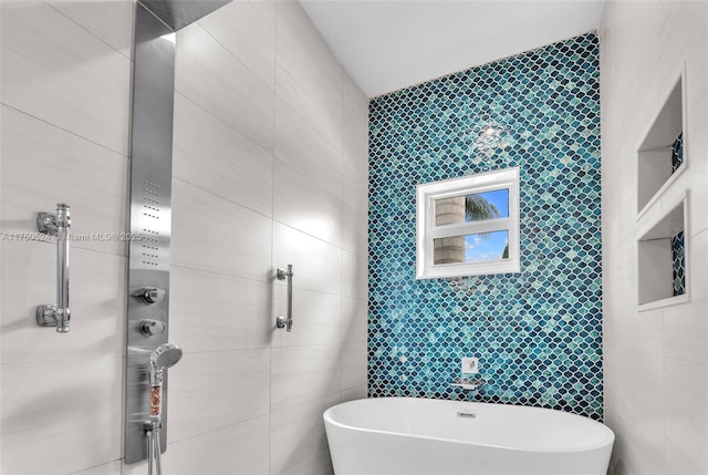 full bathroom featuring a soaking tub and tile walls