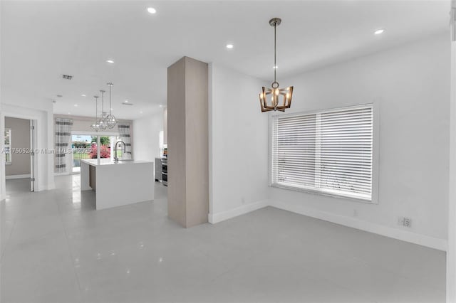 interior space with a chandelier, recessed lighting, visible vents, and baseboards