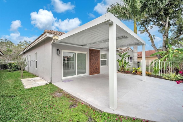 back of house with a yard, stucco siding, a patio, and fence