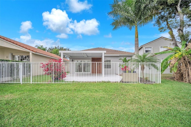 exterior space with fence, a front lawn, and stucco siding