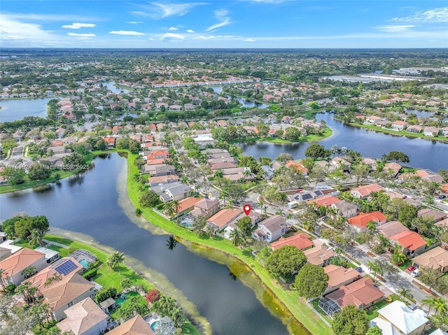 drone / aerial view featuring a water view and a residential view