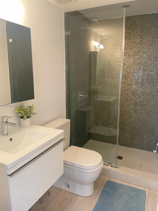 bathroom with vanity, toilet, and walk in shower