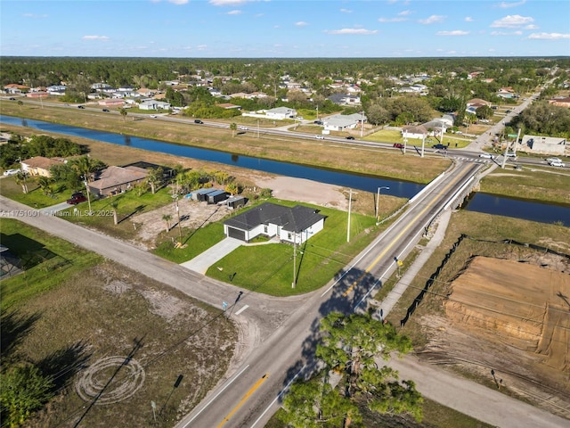 birds eye view of property featuring a water view and a residential view