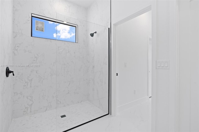 bathroom featuring marble finish floor and a marble finish shower