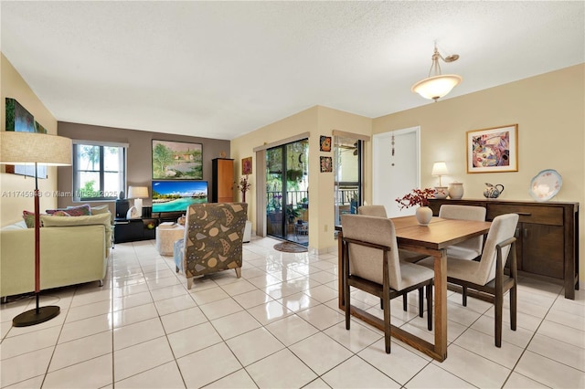 dining room with light tile patterned floors and a textured ceiling