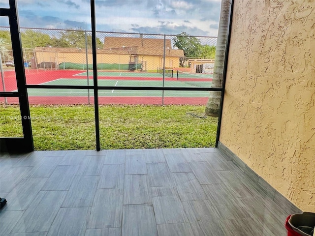 view of tennis court featuring fence