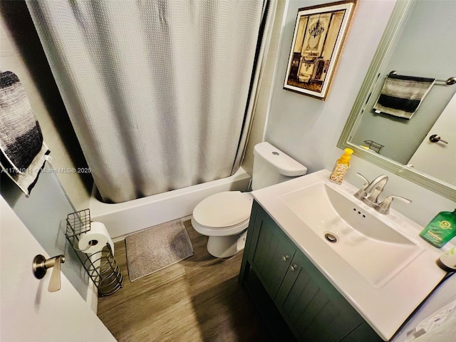 bathroom featuring wood finished floors, vanity, toilet, and shower / bath combo with shower curtain