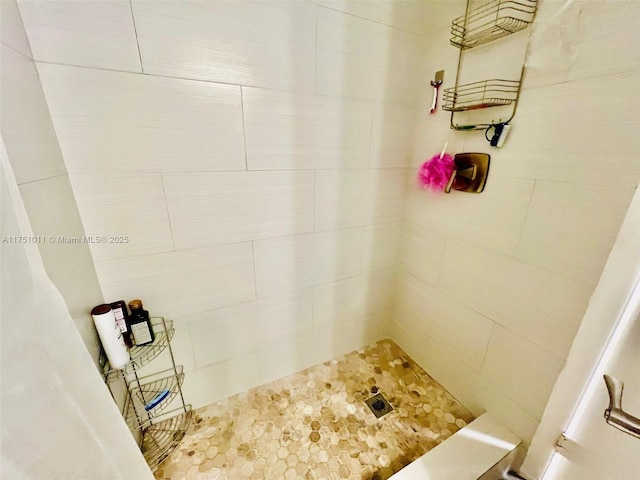 bathroom with tiled shower