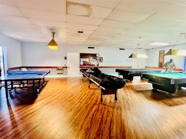 playroom with pool table, light wood finished floors, and a paneled ceiling