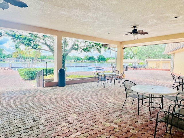 view of patio with fence and a ceiling fan