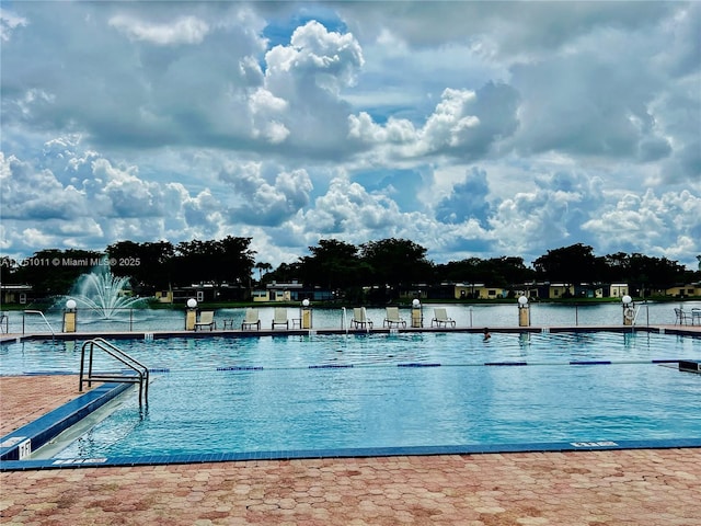 view of swimming pool featuring a water view