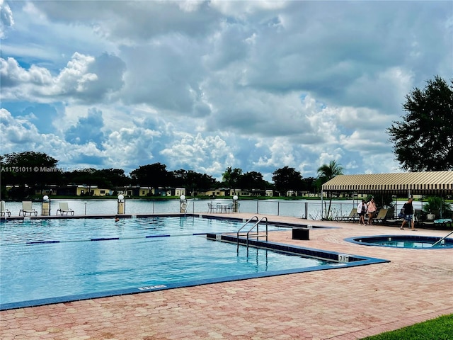 community pool featuring a patio area and a water view