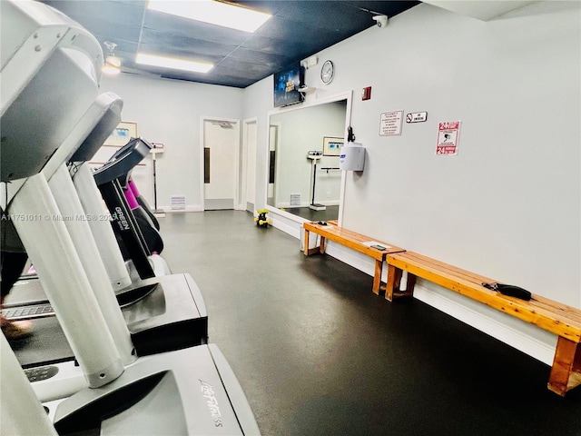 exercise room with a paneled ceiling