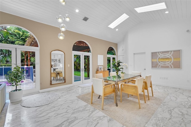 dining room featuring high vaulted ceiling, french doors, and marble finish floor