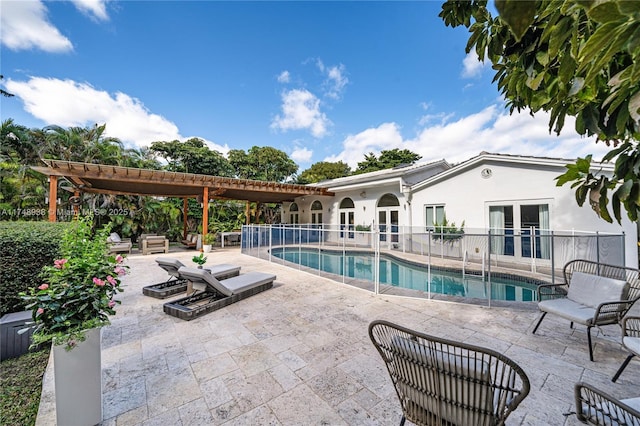 view of swimming pool with a pergola, a fenced in pool, french doors, and a patio area