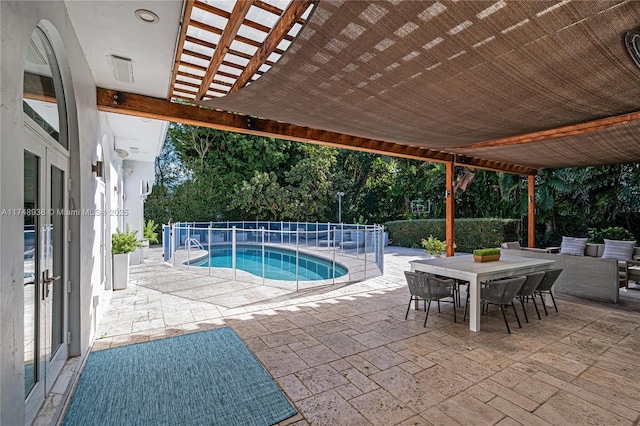 view of pool with outdoor dining area, a patio area, a fenced in pool, and a pergola