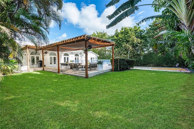 view of yard featuring a patio and french doors